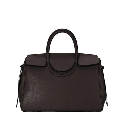 The Staud Maude Carryall is a dark brown pebbled leather handbag featuring a structured shape, top handle, flap closure, and minimal front branding.