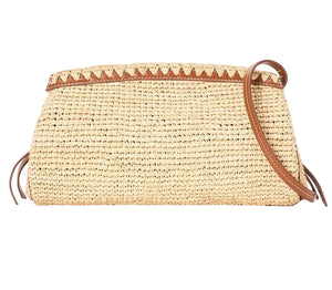 The Staud Maude Convertible Clutch is a woven straw crossbody bag with brown leather trim, a leather shoulder strap, and a triangular pattern along the top edge.