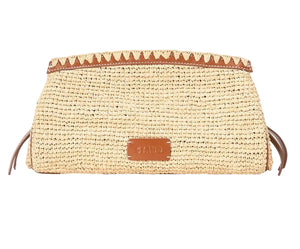 The Staud Maude Convertible Clutch features a rectangular woven straw raffia design with brown leather trim, a leather brand patch on the front, and a detachable shoulder strap, shown against a white background.