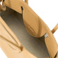 Introducing the Staud Maude Shoulder Bag: a tan, open leather handbag with a polished finish, featuring a visible interior pocket and sturdy top handles for a sleek blend of style and functionality.