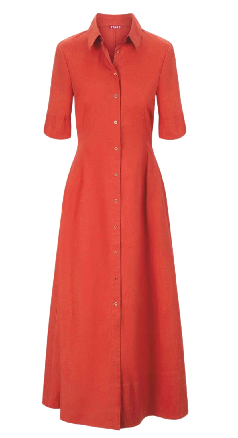 The Staud Joan Maxi Dress by Staud is a red button-up shirt dress made from stretchy cotton poplin, featuring short sleeves and a classic collar.