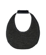 The Staud Moon Raffia Tote Bag is a black woven handbag with a rounded shape, short solid black top handle, and magnetic closure, shown against a white background.