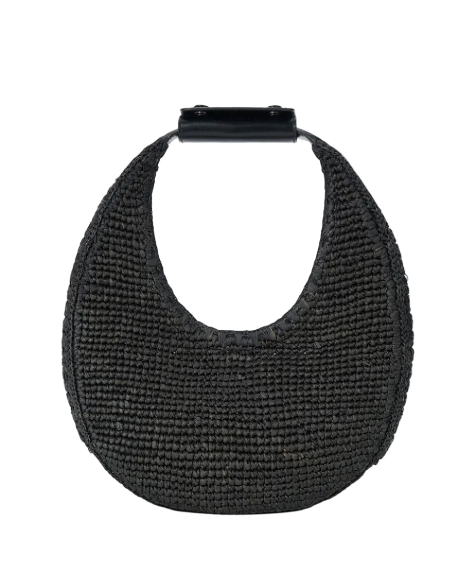 The Staud Moon Raffia Tote Bag is a black woven handbag with a rounded shape, short solid black top handle, and magnetic closure, shown against a white background.