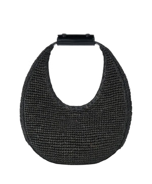 The Staud Moon Raffia Tote Bag is a black woven handbag with a rounded shape, short solid black top handle, and magnetic closure, shown against a white background.