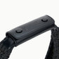 Close-up of a black woven strap with a black leather handle attached by two buttons, embossed with "STAUD"—a stylish detail perfect for your Moon Raffia Tote Bag.