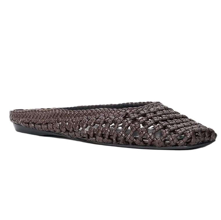 The Otto Hand-Knotted Flat Mule by Staud is a woven brown leather, closed-toe mule with a flat sole, shown against a white background.