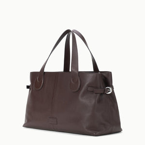 The Staud Piper Tote is a dark brown leather work bag featuring double handles and side buckle details, shown against a plain white background.
