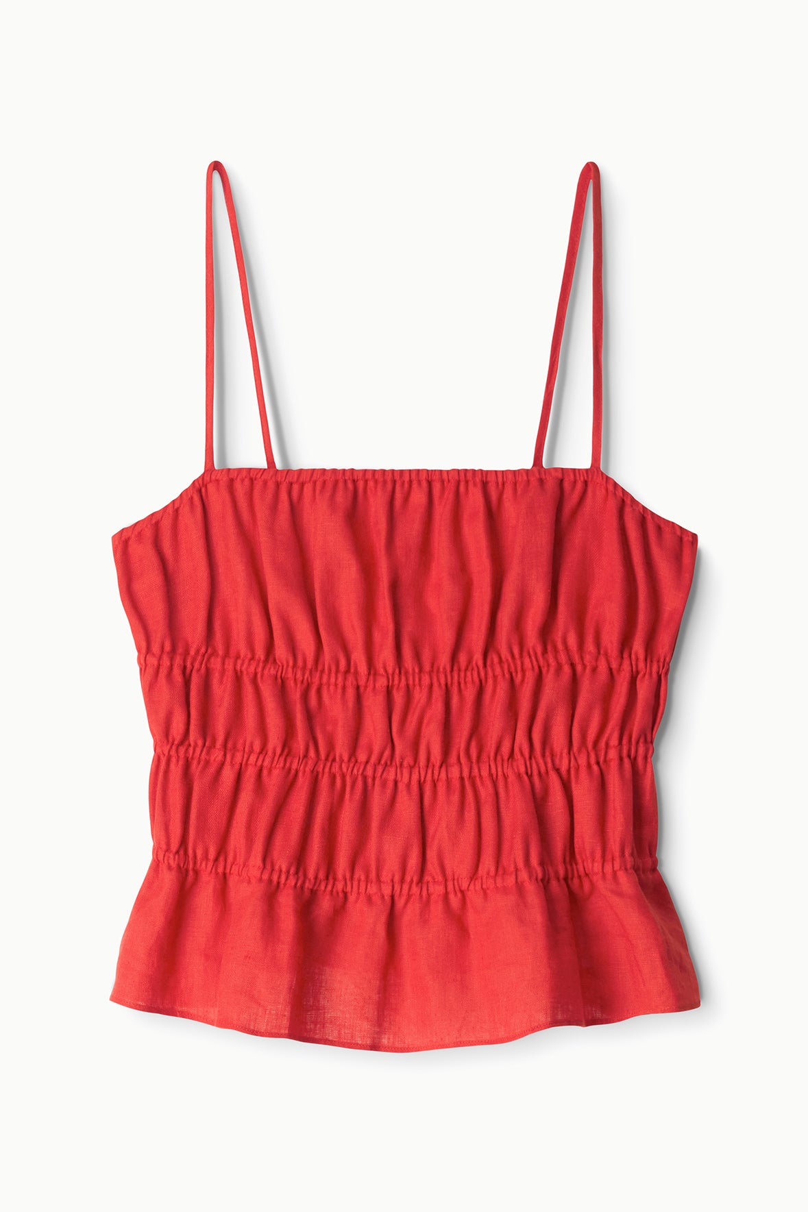 The Ayla Linen Tank by Staud is a red, sleeveless cami featuring thin spaghetti straps, a smocked bodice, and a slightly flared cropped hem, shown against a white background.