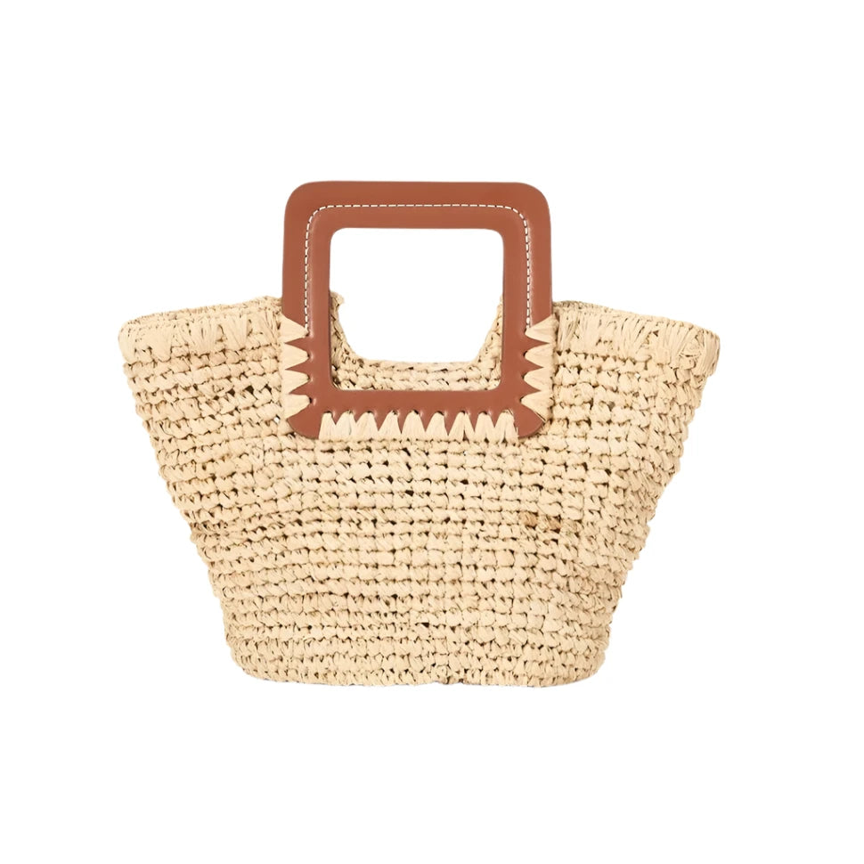 Staud Shirley Mini Bucket by Staud boasts a chic raffia weave and square brown leather handles for a versatile look.