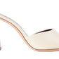 A white Staud Sloane Heel mule with a wooden heel, perfect for adding a touch of sophistication to any outfit.