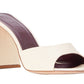 A pair of white leather mule sandals with a chunky block heel, the Staud Sloane Heel.