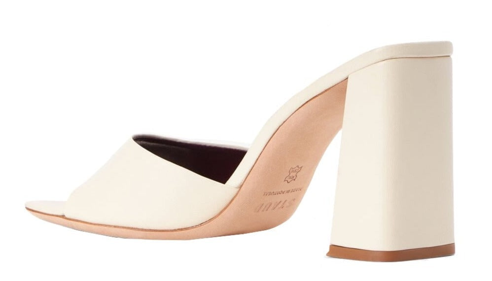 A white leather mule with a chunky block heel, like the Staud Sloane Heel by Staud.