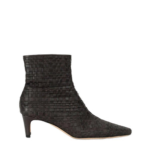The Staud Wally Ankle Boot is a black woven leather boot featuring a pointed toe and mid-height blade heel, shown on a white background.