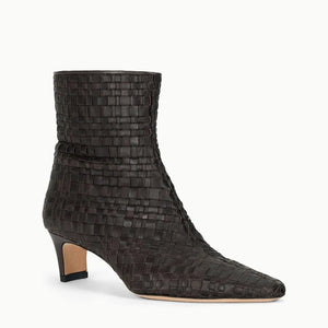 The Staud Wally Ankle Boot features dark brown woven leather, a low blade heel, pointed toe, and convenient side zipper for easy wear.