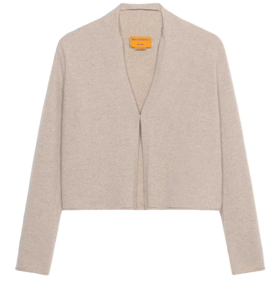 The Stealth Cardigan by Guest in Residence is a beige, cropped cashmere cardigan with long sleeves and an open front, shown against a white background.