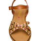 The Girls’ Gillian Sandal by Steve Madden Kids features a brown strappy design with two crisscross straps decorated with colorful rhinestone embellishments, an ankle strap, and a flat sole, shown from above.
