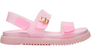 Introducing the Girls’ Jelly Mona Sandal by Steve Madden Kids—a translucent pink sandal featuring two adjustable straps, a secure back strap, a ridged sole with a subtle flatform design, and a chic decorative gold buckle on the side—perfect for your little fashionista.