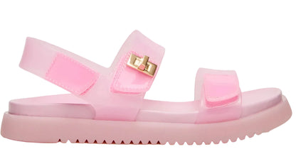 Introducing the Girls’ Jelly Mona Sandal by Steve Madden Kids—a translucent pink sandal featuring two adjustable straps, a secure back strap, a ridged sole with a subtle flatform design, and a chic decorative gold buckle on the side—perfect for your little fashionista.