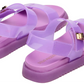 A pair of Steve Madden Kids Girls’ Jelly Mona Sandals in purple, featuring a trendy flatform design with thick soles, adjustable straps, and shiny gold buckles—perfect for the little fashionista—displayed on a white background.