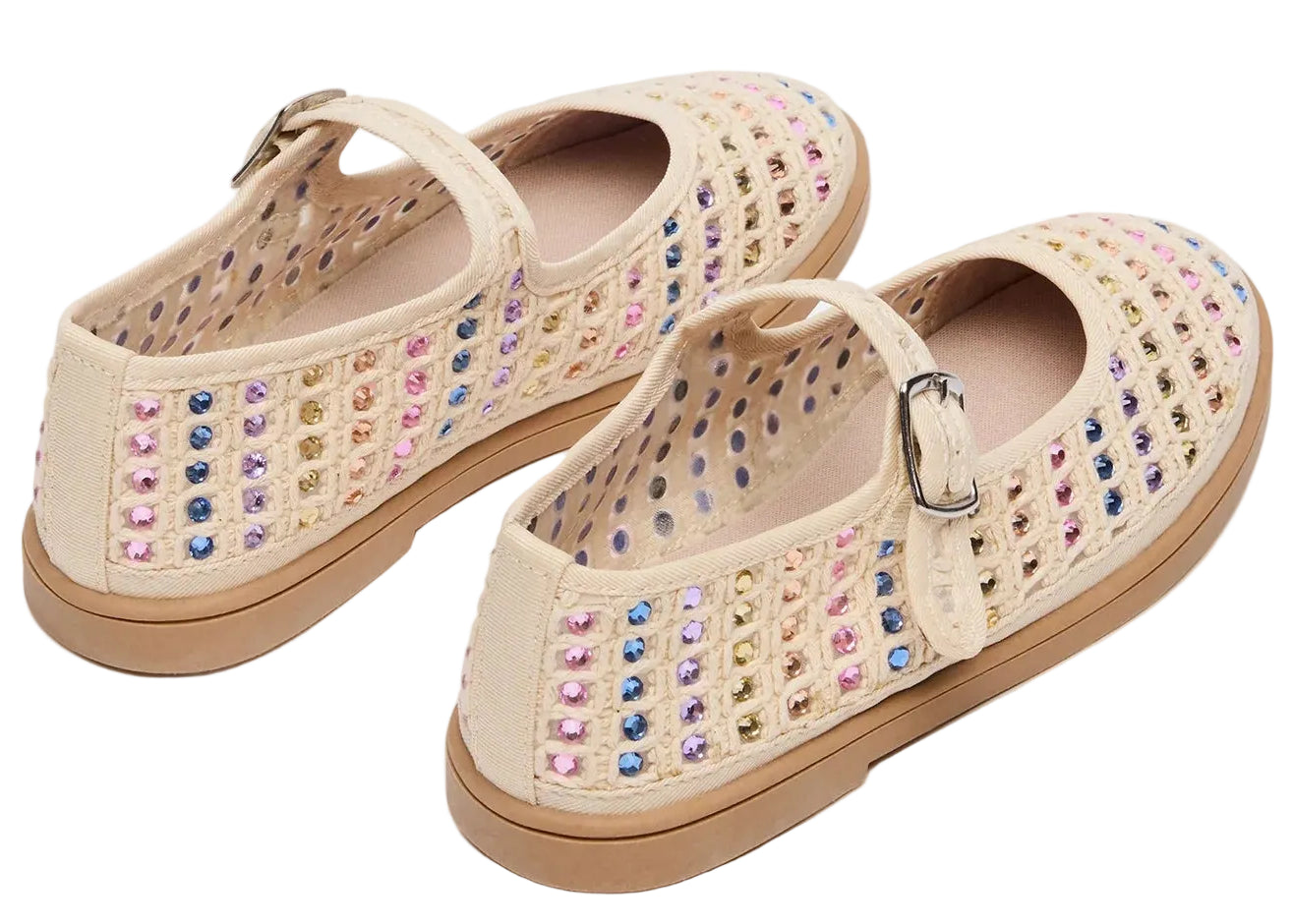 A pair of Steve Madden Kids Girls’ Roree Rhinestones Flats in beige, featuring a buckle strap and multicolored rhinestone embellishments on the sides and tops.