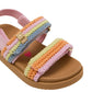 The Steve Madden Kids Toddlers’ Mona Sandal features a tan flatform sole, pink straps, and pastel-colored crocheted bands in shades of pink, orange, yellow, green, and blue. A gold buckle detail accents the front strap for added charm.