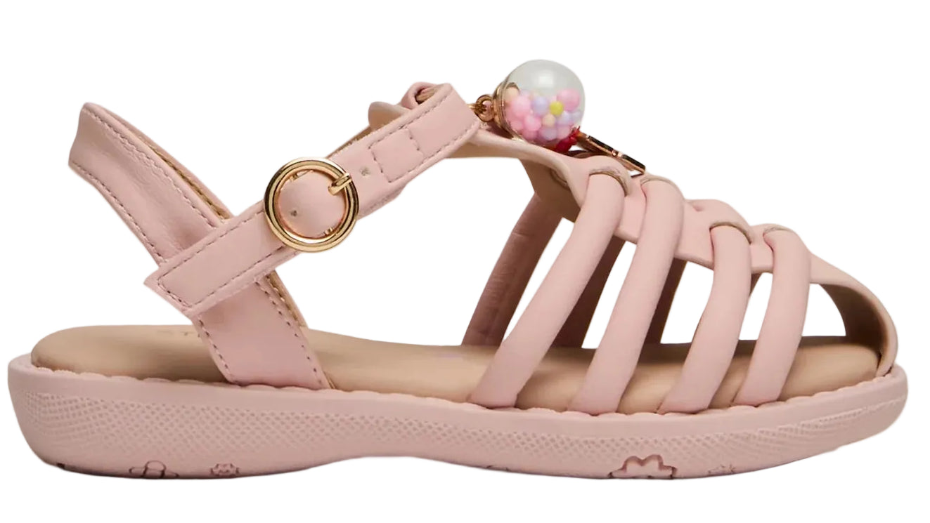 The Steve Madden Kids Toddlers’ Pocket Charmed Sandal is a light pink children’s sandal featuring multiple straps, a closed heel, a gold buckle, and a decorative bead with colorful accents on top.