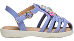 The Steve Madden Kids Toddlers’ Pocket Charmed Sandal features a light purple strappy design with a white sole, gold buckle, and colorful bead charms spelling “LOVE,” plus a pink flower detail on the top strap.