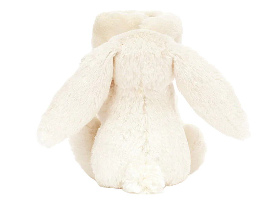 The Blossom Cream Bunny 'Berry' Soother by Jellycat features soft cream fur, floppy ears, and a round tail—perfect as a gift for babies or paired with a snuggle blanket for added comfort.