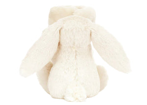 The Blossom Cream Bunny 'Berry' Soother by Jellycat features soft cream fur, floppy ears, and a round tail—perfect as a gift for babies or paired with a snuggle blanket for added comfort.
