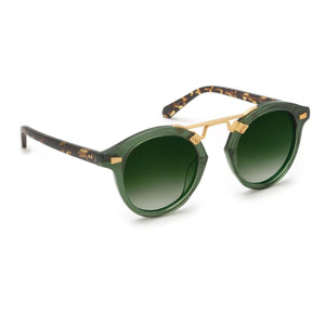 Krewe STL II Sunglasses feature an oversized green round frame with a gold metal bridge, gradient green lenses, and dark arms accented by a tortoiseshell pattern—an elegant nod to the cast-iron balconies of the French Quarter.