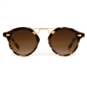 Krewe STL Nylon Sunglasses feature a round, oversized tortoiseshell-patterned frame, brown gradient flat nylon lenses, and gold metal accents on the bridge, shown from the front.