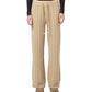 A person models the Guest in Residence Stripe Lounge Pant, featuring beige and cream stripes, paired with a black long-sleeve top; photo shows them from the waist down.