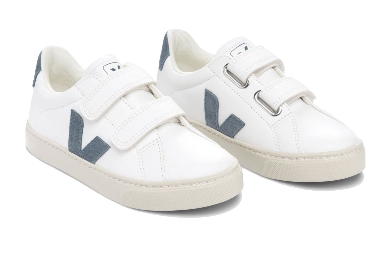 The Veja Junior Esplar Velcro Chromefree Leather Sneaker by Veja is a pair of white sneakers made with ChromeFree leather, featuring two velcro straps and gray 'V' logos on the sides, complemented by gray heel patches.