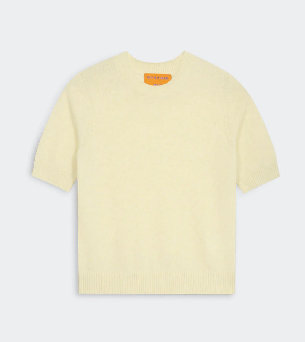The Guest in Residence Sweater Tee is a short-sleeve, pale yellow jersey crewneck featuring ribbed collar, cuffs, and hem, shown flat on a plain background.