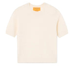 The Compass Sweater Tee by Guest in Residence is a women's lightweight cream cashmere short-sleeve sweater with a classic crew neck and knit design, shown flat on a white background.