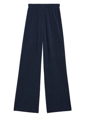 The Zephyra Flare Pants by Suzie Kondi are navy blue wide-leg pants featuring a high waist and elastic waistband, shown on a white background.
