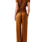 A woman is seen from behind, wearing a short-sleeved brown ribbed top and Sablyn’s Lexi Lower Rise Relaxed Pull On Pant.