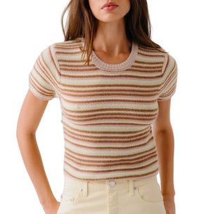 A woman wears the Sablyn Jude Short Sleeve Tee, a ribbed knit top with multicolor stripes in brown, beige, and cream, paired with high-waisted light yellow pants.