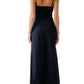 A woman is shown from the back wearing the Sablyn Ada V-Neck Cami with Lace, featuring thin straps and delicate trim, paired with high-waisted wide-leg black pants.
