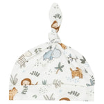 Introducing the Angel Dear Delicate Safari Knotted Hat by Angel Dear: a soft bamboo viscose baby hat featuring an adjustable knotted top and adorned with enchanting animals like elephants, lions, and giraffes, along with delightful plants.