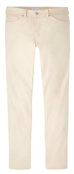 The Peter Millar Signature Sateen Five-Pocket Pant in beige offers a superior stretch, featuring a slim-fit design with five-pocket styling, front pockets, and belt loops against a white backdrop.