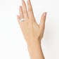 A left hand with natural nails wears the Lie Studio Sandra Ring, a wide sterling silver band on the middle finger, set against a plain white background.