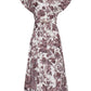 The Sawyer Dress by Cara Cara showcases a timeless shirtdress silhouette with short sleeves, a collared neckline, front button closure, and a belted waist. Its all-over maroon floral and paisley print brings an elegant touch to this effortlessly chic poplin A-line dress.