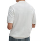 A man is seen from behind wearing a white Rag & Bone Saxon Silk-Cotton Polo Shirt with textured shoulder panels and blue jeans, set against a plain white background.