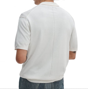 A man is seen from behind wearing a white Rag & Bone Saxon Silk-Cotton Polo Shirt with textured shoulder panels and blue jeans, set against a plain white background.