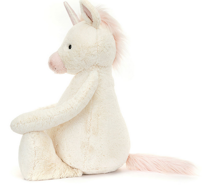 A Jellycat Bashful Unicorn, Giant plush toy with vanilla fur, a pink mane, and a single holographic horn sits upright against a white background.