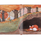 A two-page illustration in a children's book shows a fox sleeping underground in a burrow surrounded by autumn trees. The text on the left page describes the fox dozing off and feeling warm, making it an ideal bedtime story. This giftable hardback edition of **Jellycat Warm in the Storm Book** by **Jellycat** is perfect for young readers.