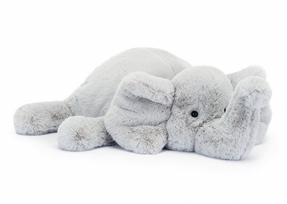 A Jellycat Wanderlust, this plush toy elephant lies on its side with its trunk curled upward, perfect for any adventurer.