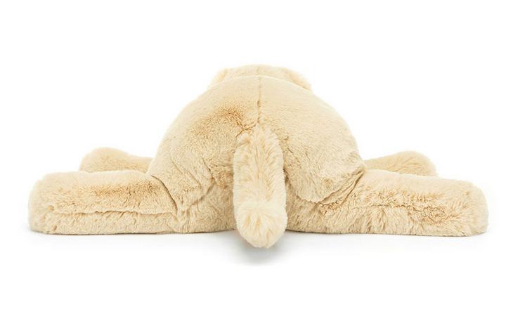 A Jellycat Wanderlust, viewed from the back, lying flat on its stomach with limbs spread outwards—a chilled softie perfect for any traveller's friend.