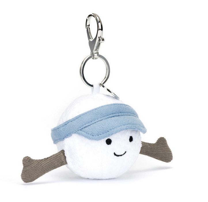 A small, plush keychain shaped like a white ball with a smiling face, outstretched brown arms, and a blue visor, perfect as the Jellycat Amuseables Sports Golf Bag Charm. It has a metal clasp attached to the top, making it an adorable golf bag charm from Jellycat.